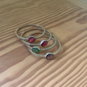 Set of green, pink, purple stone stacking bracelets. Can be worn individually.